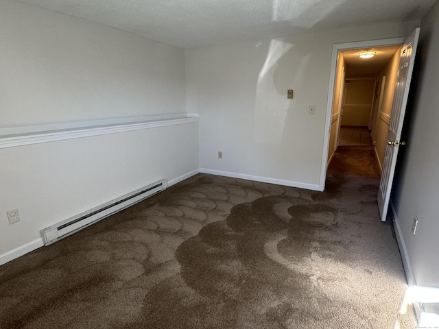 carpeted spare room featuring a baseboard radiator and baseboards