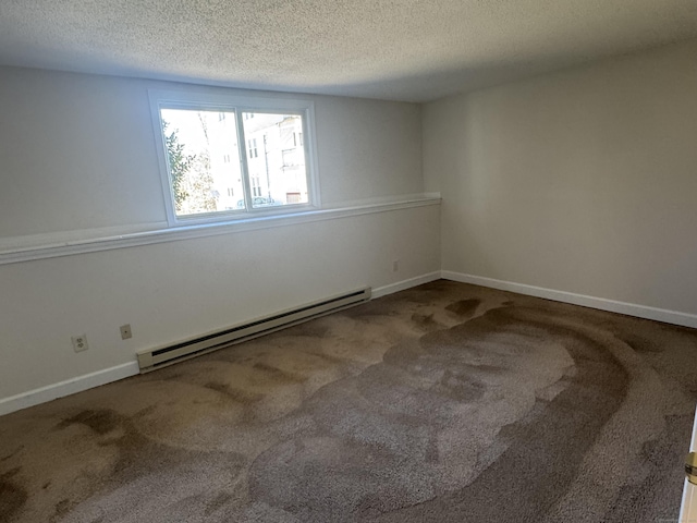 carpeted empty room with a baseboard radiator, a textured ceiling, and baseboards