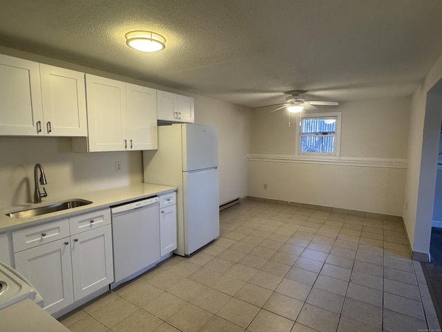 kitchen with white appliances, a sink, and white cabinets