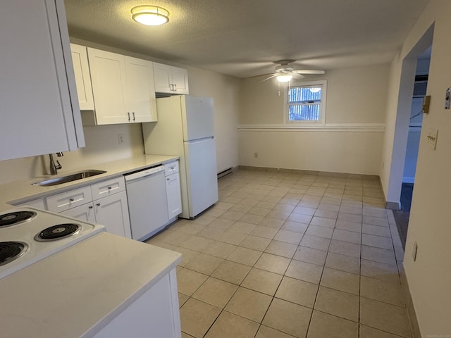 kitchen with white appliances, white cabinets, ceiling fan, light countertops, and a sink