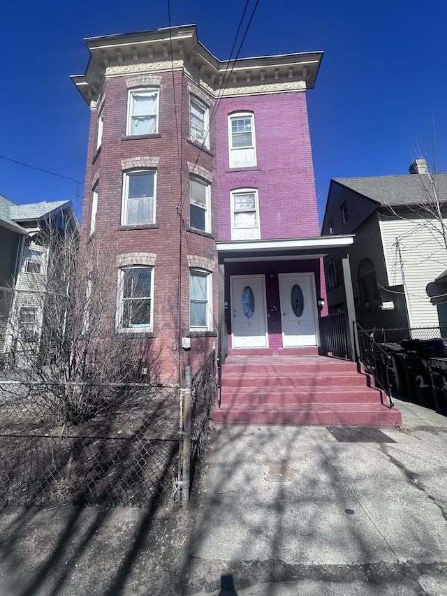 view of front of property featuring covered porch and brick siding