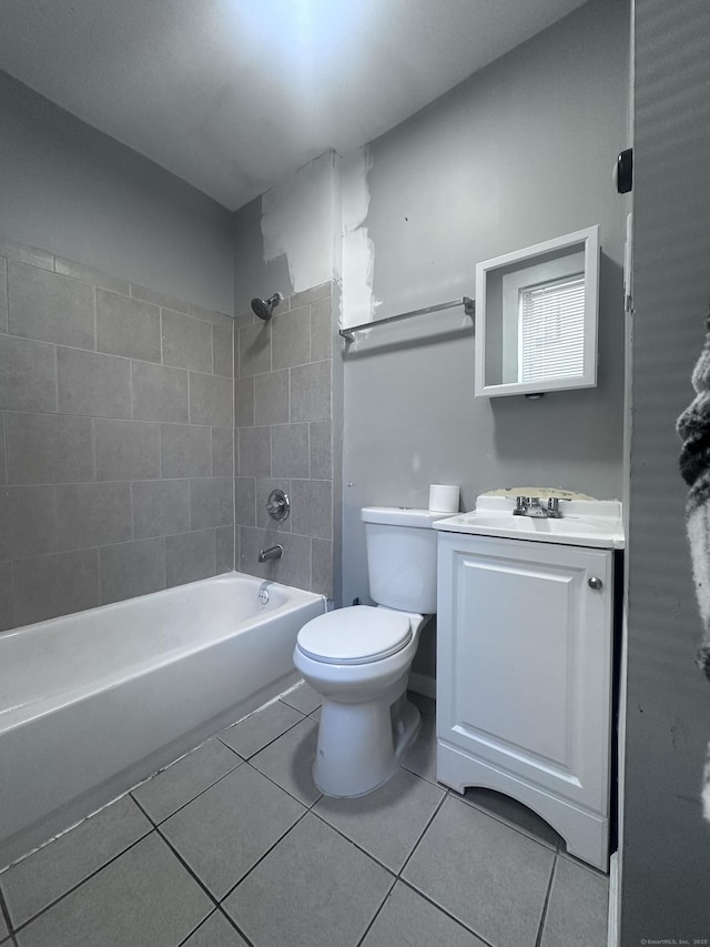 bathroom featuring toilet, shower / bathtub combination, tile patterned flooring, and vanity