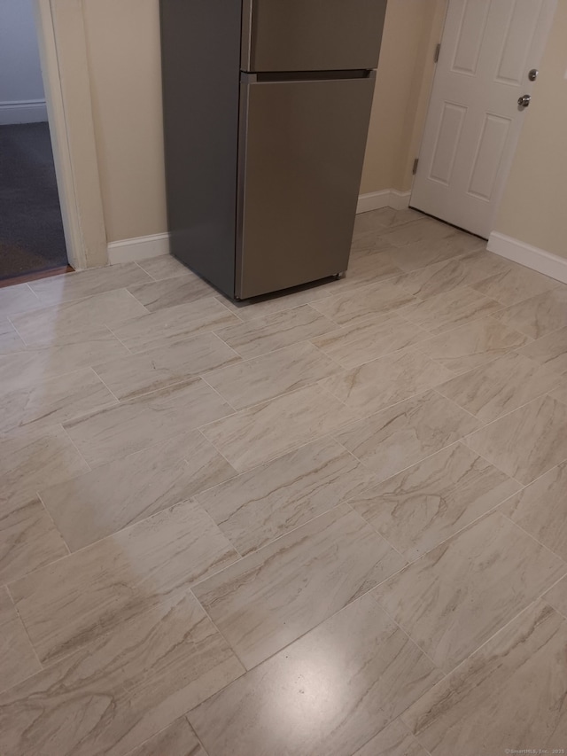 details featuring freestanding refrigerator and baseboards