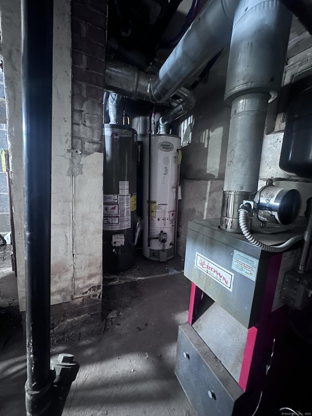 utility room with gas water heater and water heater