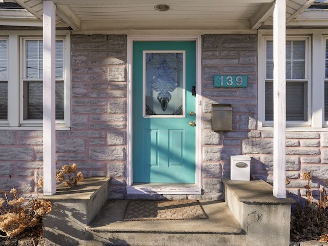 doorway to property featuring stone siding