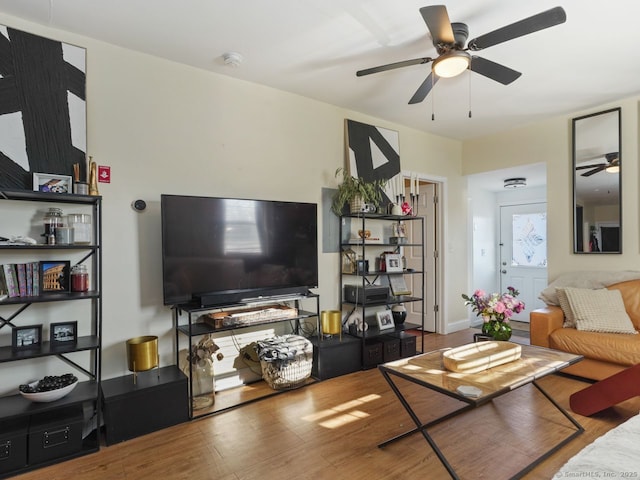 living room with ceiling fan and wood finished floors