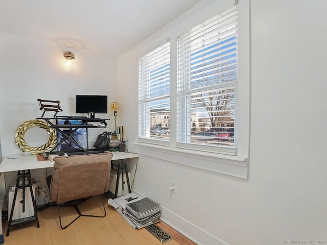 home office featuring light wood-style flooring and baseboards