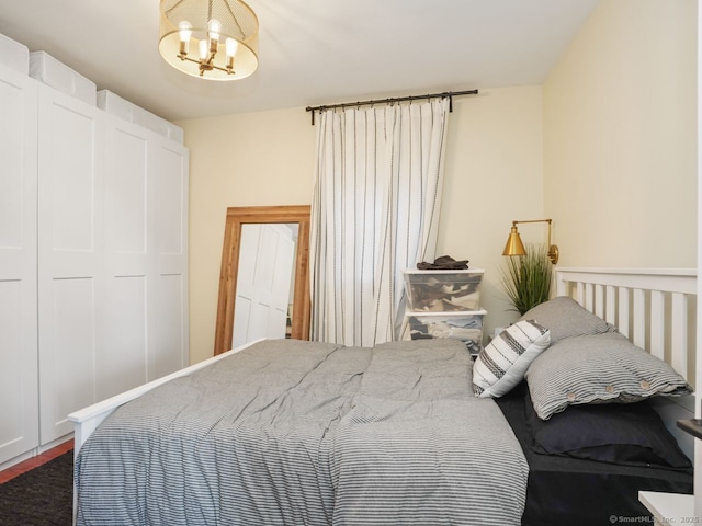 bedroom featuring an inviting chandelier