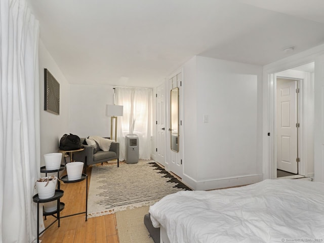 bedroom featuring wood-type flooring and baseboards