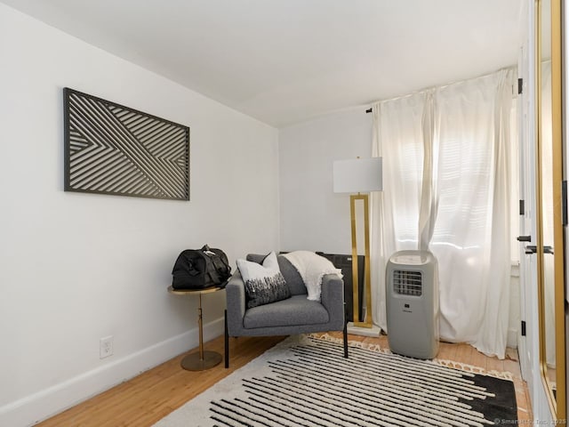 sitting room featuring baseboards and wood finished floors