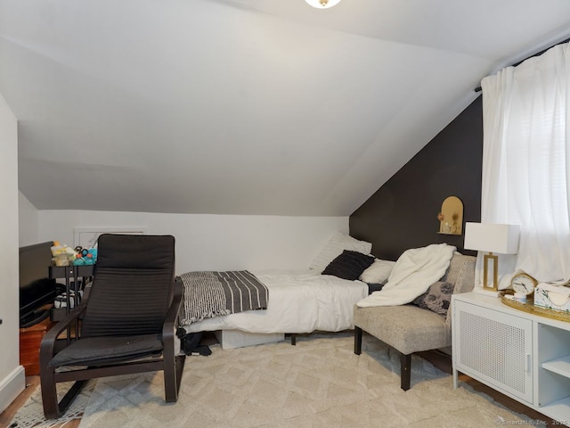 carpeted bedroom featuring lofted ceiling