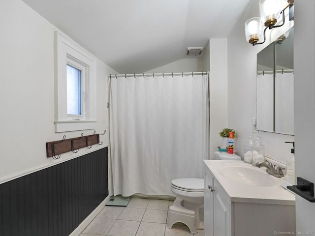 bathroom featuring lofted ceiling, toilet, visible vents, vanity, and tile patterned floors