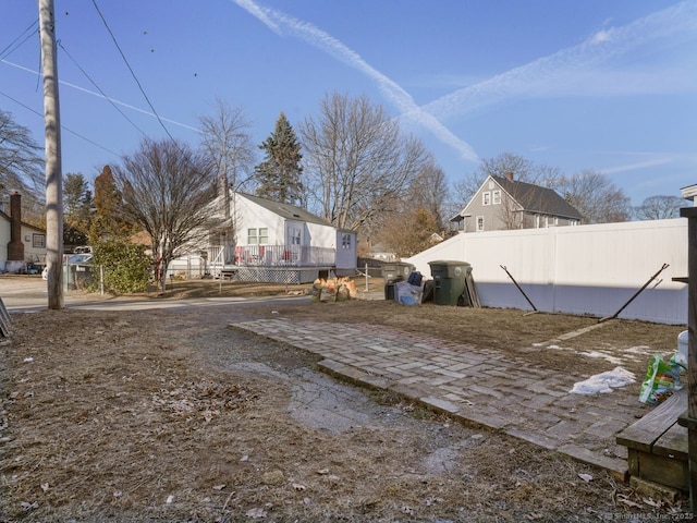 view of yard with fence and a deck