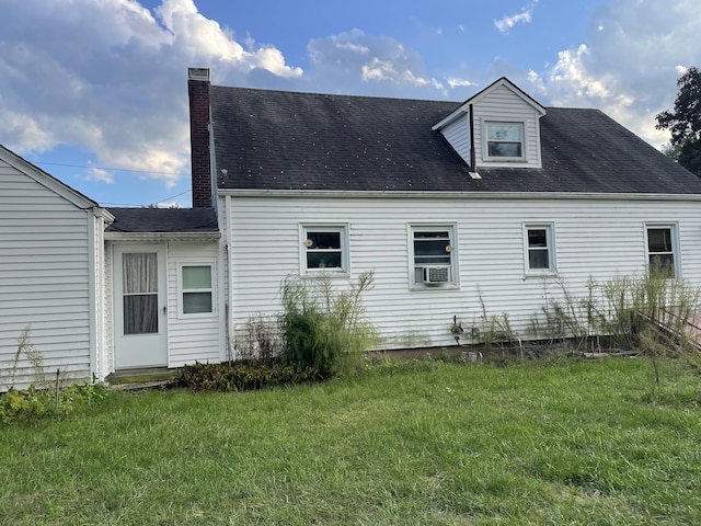 back of property with a yard, cooling unit, and a chimney