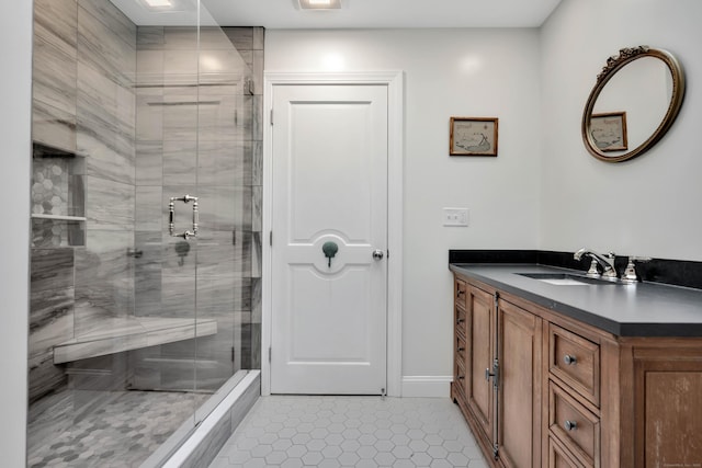 full bath with tile patterned flooring, a stall shower, and vanity