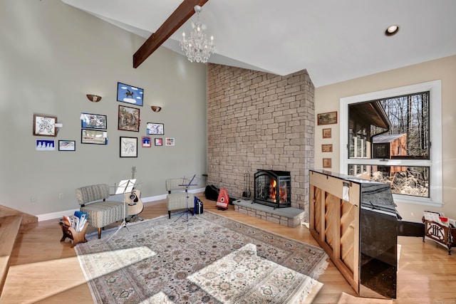 living room with wood finished floors, a fireplace, and baseboards