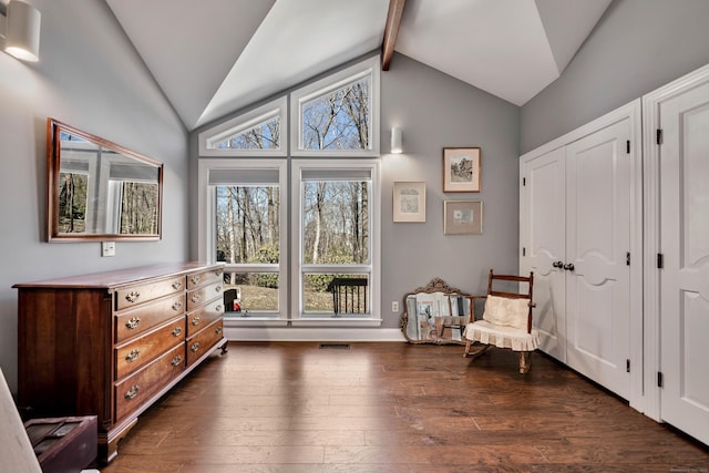 sitting room featuring lofted ceiling with beams and dark wood-style flooring