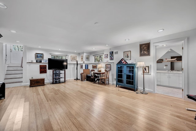 unfurnished living room with recessed lighting, wood-type flooring, and stairs