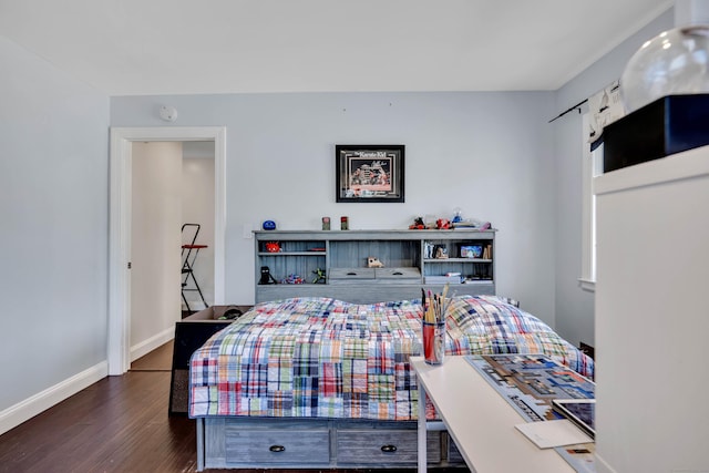 bedroom featuring baseboards and dark wood-type flooring