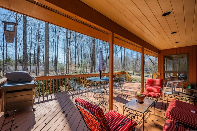 deck featuring a grill and outdoor dining space