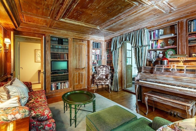 sitting room with wood walls, coffered ceiling, wood finished floors, wood ceiling, and ornamental molding