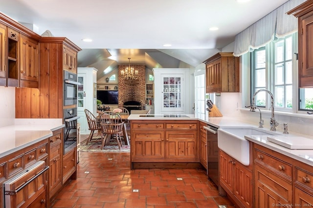 kitchen with dishwasher, light countertops, vaulted ceiling, a sink, and a warming drawer