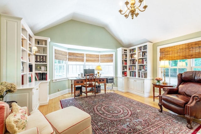 sitting room featuring a chandelier, lofted ceiling, and light wood-style flooring