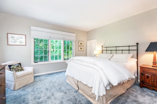 carpeted bedroom featuring baseboards