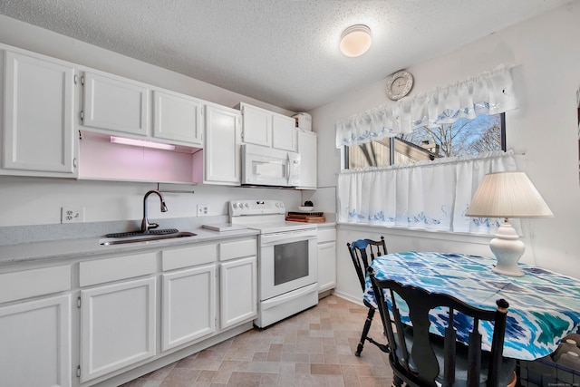 kitchen featuring a textured ceiling, white appliances, a sink, white cabinetry, and light countertops