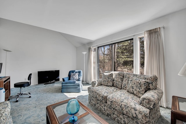 living area featuring lofted ceiling and carpet floors