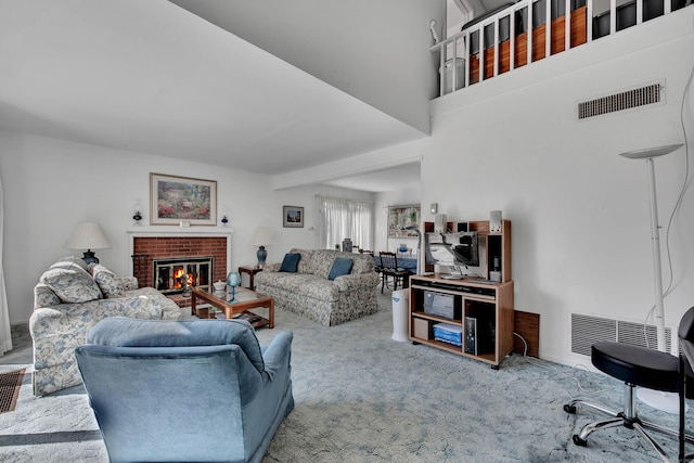 living room with carpet floors, a fireplace, and visible vents