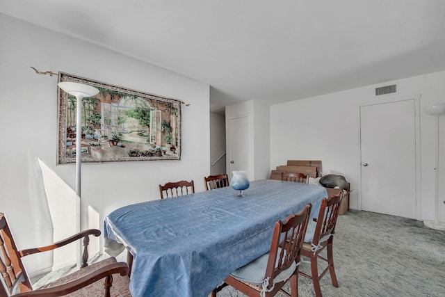 dining room featuring carpet flooring and visible vents