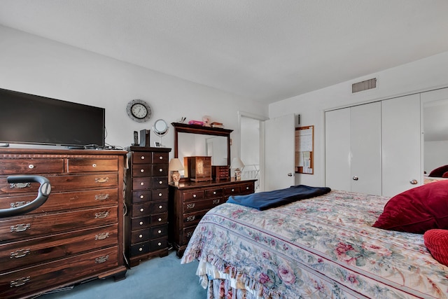 carpeted bedroom with a closet and visible vents