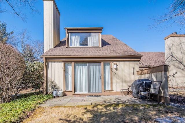 back of property featuring roof with shingles and a patio area