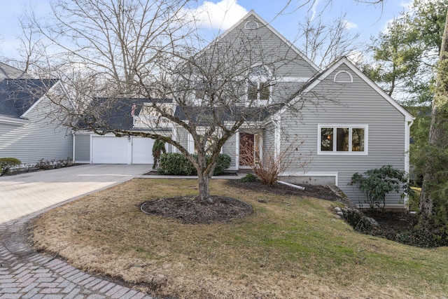 view of front of home featuring concrete driveway and a front lawn