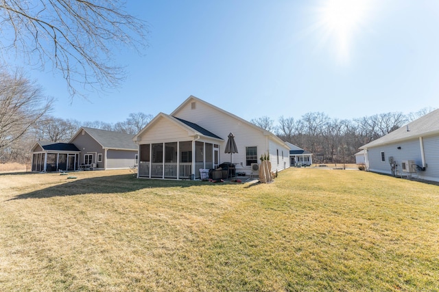 back of house featuring a sunroom and a yard