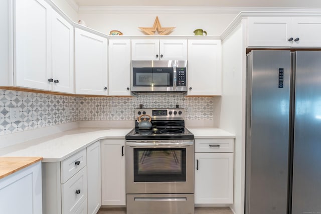 kitchen featuring white cabinets, backsplash, stainless steel appliances, and light countertops