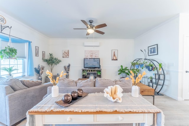 living room featuring crown molding, a wall mounted AC, light wood-style floors, a ceiling fan, and baseboards