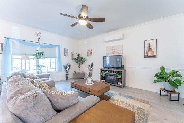 living area featuring baseboards, an AC wall unit, light wood-style floors, and crown molding