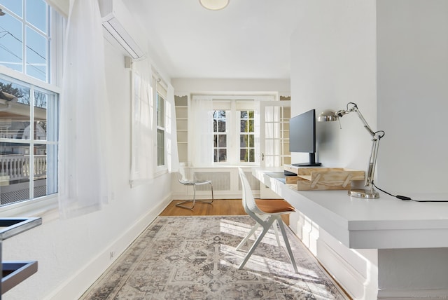 home office with baseboards and wood finished floors