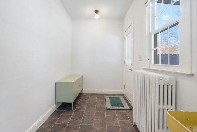 entryway featuring radiator and baseboards