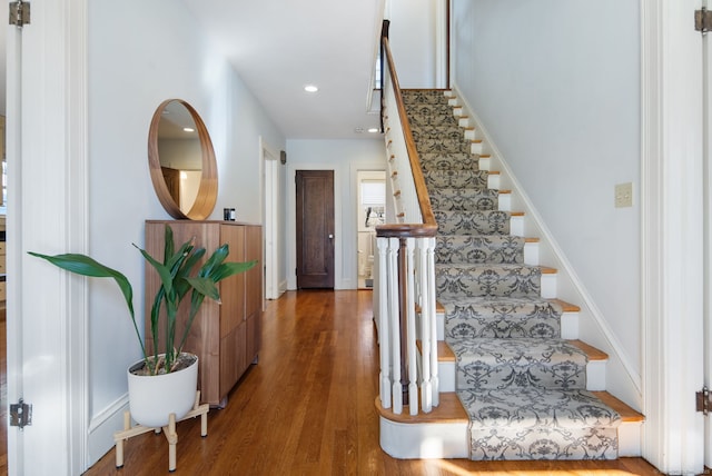 stairway featuring wood finished floors