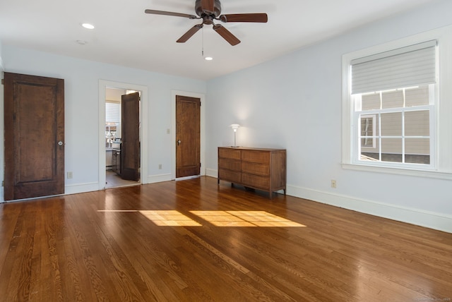 unfurnished bedroom featuring ceiling fan, connected bathroom, recessed lighting, wood finished floors, and baseboards