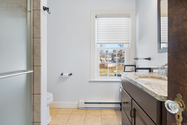 bathroom with a baseboard radiator, toilet, vanity, tile patterned flooring, and baseboards