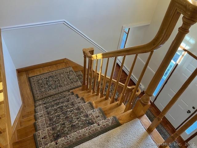 stairs featuring baseboards and wood finished floors