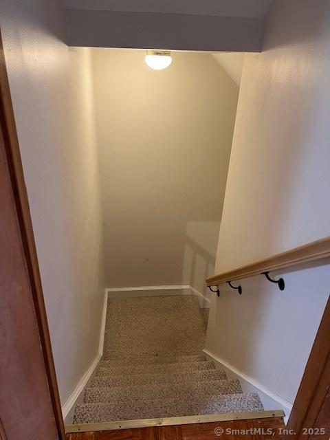 stairway featuring baseboards