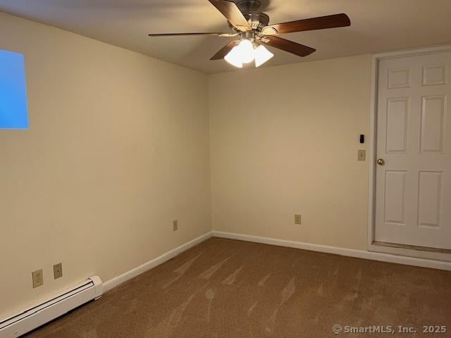 spare room with baseboards, a ceiling fan, dark colored carpet, and a baseboard radiator