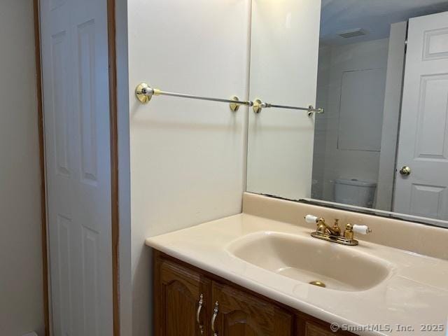 bathroom with vanity and toilet