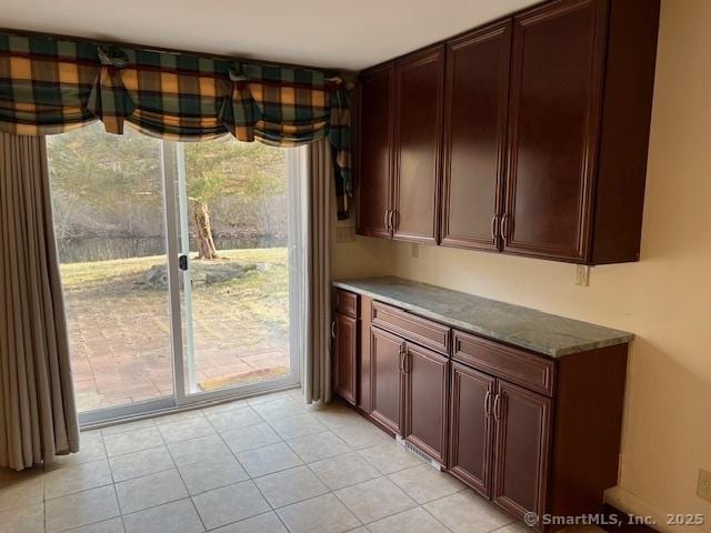 kitchen with light tile patterned flooring