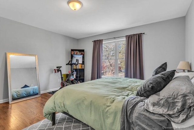 bedroom featuring wood finished floors and baseboards